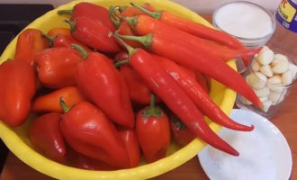 How to prepare adjika without cooking for the winter from tomatoes and garlic according to the classic recipe? Before you start preparing spicy raw adjika, you need to prepare all the products necessary for this. Measure out vinegar, sugar and salt; Peel the garlic, weigh the bell pepper.