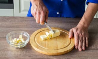 How to make delicious shortbread cookies at home? Take fresh butter and cut it into cubes using a sharp knife. Place the butter in a convenient container and set it aside to let it melt. This will take you about half an hour.