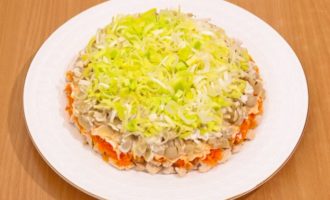 Then there is a layer of fried champignons, covered with a mesh of mayonnaise and a layer of onions, also sprinkled with mayonnaise.