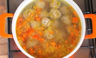 Fill a convenient saucepan with water and bring it to a boil. You can add bay leaves and dried herbs if desired. Carefully place the meatballs into boiling water and cook for about ten minutes. Then add the diced, pre-peeled potatoes there.