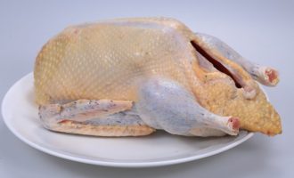 How to cook juicy Peking duck at home? The bird must be completely defrosted, gutted and thoroughly washed, dried, and fat trimmed from the neck and tail.