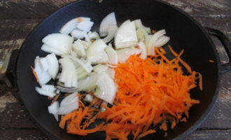 How to cook delicious pollock with carrots and onions in the oven? Start by rinsing and peeling the root vegetables. Cut the onion into half rings and grate the carrots on a medium grater. Saute the vegetables in a frying pan with vegetable or olive oil until the onion becomes transparent.