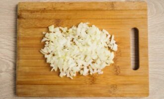 Peel the onion and chop it with a sharp knife.