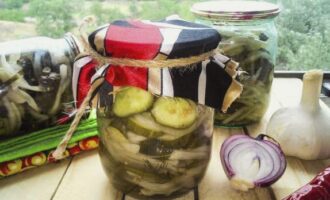 Then roll up the lids, turn the jars upside down, cover them with a warm blanket and leave until completely cool. In winter, you can enjoy the most delicate salad of cucumbers and onions.