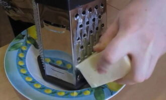 Grind the hard cheese using a coarse grater.