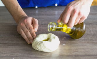 Make a hole in the lump and pour olive oil into it.