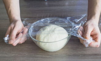 Knead the dough with butter until smooth and place in a plate, cover with cling film and leave for about an hour in a warm place. This time is enough for the dough to rise.