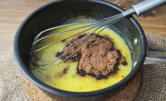 We wait until the piece of butter has completely melted, then you can remove it from the stove. Add cocoa mixture and begin whisking.