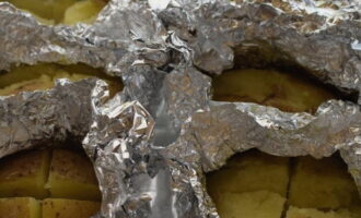 Remove the potatoes from the oven and carefully unfold the foil to expose the cut area. Return the vegetables to the oven on the top rack and brown them for ten minutes.