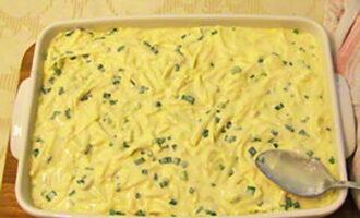 Pour the cheese and egg filling on top and smooth it out with a spoon.