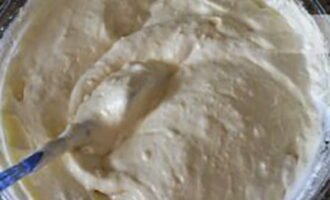 Add sifted flour to the whipped mixture in several additions and mix the dough with a spatula or spoon.