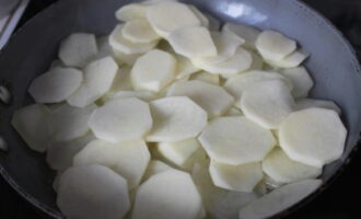 Heat a frying pan, pour in vegetable oil. Then add the potatoes. Fry for a few minutes, then stir the potatoes.