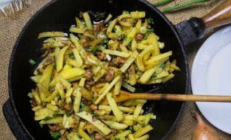 When the potatoes are almost ready, add mushrooms and onions, salt and season to taste and fry for another 5-10 minutes. Serve the dish hot with sour cream and herbs.