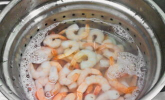 Place frozen shrimp in a deep container and pour boiling water over it. Then drain through a sieve or colander.