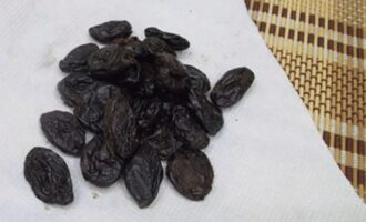 Pour boiling water over the prunes, leave for 5 minutes, then wash and dry.