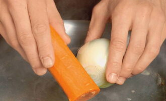 To cook cabbage soup from sauerkraut, pour 2 liters of cold water into a pan and put the meat in it. Bring to a boil over high heat. At this time, peel one carrot and onion. After the broth boils, reduce the heat. Remove the resulting foam and add vegetables. Cook for one and a half hours.