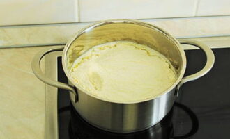 As soon as the mixture boils, pour the sifted flour into it.