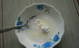 Place starch in a small plate. Fill it with two tablespoons of cold water.