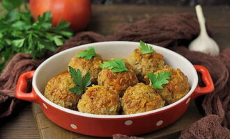 Decorate juicy meatballs in tomato sauce with fresh herbs and serve!