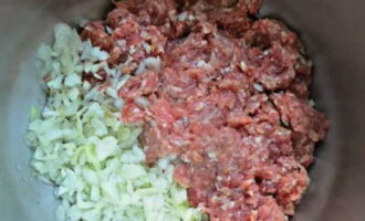 If for some reason you were unable to purchase minced pork, use beef or lamb for the dish. You can also mix several types of meat. Minced pork must be twisted through a meat grinder. You can also twist onions with it. However, this is not recommended. Transfer the finished minced meat to a deep bowl.To it we add chopped onions, herbs, suneli hops (they give the dish a Caucasian flavor) and spices. Melt the butter a little in the microwave. Add it to the minced meat. Mix the meat well. Now we need to beat the minced meat into a bowl. As a result, its consistency should become viscous so that the lula kebab can keep its shape and not fall apart. 