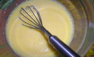 Using a whisk or fork, lightly beat the eggs with the milk until coarse foam appears.