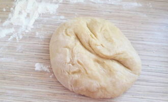 Remove the bowl from the water bath and knead a soft elastic dough, adding the remaining flour. Wrap the dough in cling film and place in the refrigerator for 30-40 minutes.