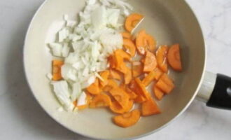 Let's start preparing the vegetables. Wash the carrots and onions thoroughly. Cut the onion into small pieces. Cut the carrots into half rings. It is not a mandatory ingredient for fish soup. However, without carrots, the color of the broth will become faded and lose its richness. Let the frying pan heat up. Add vegetable oil to it. Fry onions and carrots. A sign of readiness will be the golden color of the vegetables. 