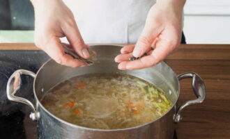 Häll potatisen i pannan med buljong och grönsaker. Koka upp och låt stå på spisen i 5 minuter. Därefter skickar vi svart och kryddpeppar, lagerblad. Salt. Koka i ytterligare 10 minuter.