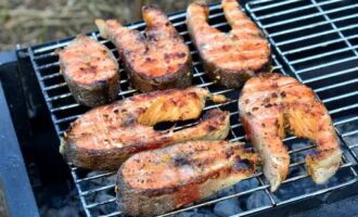 Place the marinated fish on the grill and fry for about 10 minutes on each side.