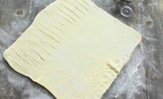 Roll out the puff pastry. It should not be too thin. We make small cuts on one side.