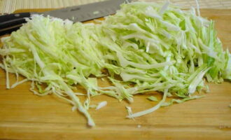 The cabbage needs to be finely chopped and cooked for about 10 minutes. Then drain the liquid and squeeze the cabbage a little to remove excess juice. 