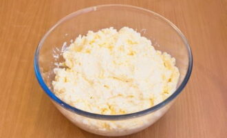 Next, add softened butter to the cottage cheese and stir.