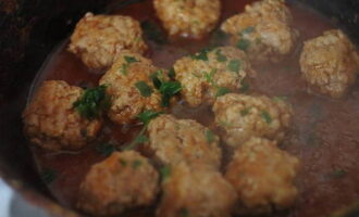 Then add water and tomato paste, reduce heat and simmer covered for 20-25 minutes, turning the meatballs occasionally. At the end, add chopped herbs.