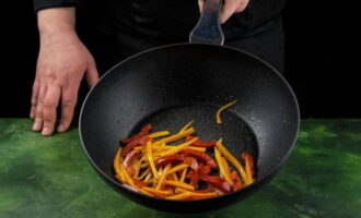 Grease a frying pan with a little olive oil and fry the carrots and peppers over high heat for about a minute.