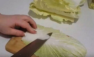 Disassemble the head of cabbage into leaves. Cut off a layer of dense white base.