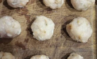 We begin to make meatballs from the minced meat. Wet your hands in cold water so that the minced meat does not stick to your hands too much. We form small balls, smoothing them on all sides. 