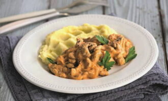 Serve beef stroganoff with sour cream sauce along with your favorite side dish, garnished with fresh parsley.