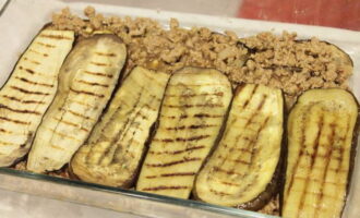 Preheat the oven to 200°C and bake eggplants with minced meat in it for 30-35 minutes.