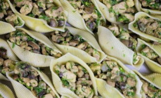 Pour a small amount of sauce into the bottom of the baking dish and place the stuffed shells on it.