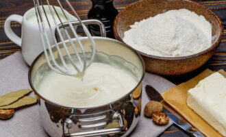 While the minced meat arrives, you need to prepare a cream-based sauce. In a saucepan, mix 50 grams of clean water with flour, whisking. Add the remaining amount of water and cream, season with salt and nutmeg and bring to a boil over low heat. It is important to constantly stir the sauce so that lumps do not form and it does not separate. When it thickens slightly, turn off the heat.