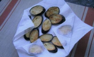 After frying, pat the eggplants dry with a paper towel to remove excess oil.