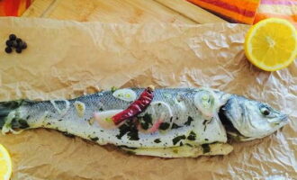 Appetizing and juicy sea bass is ready in the oven. Serve the dish to the table!