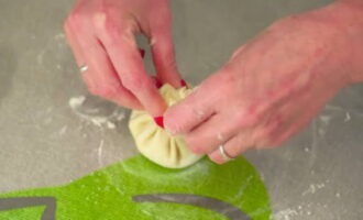 Gather the edges of the dough in the center and seal them well.