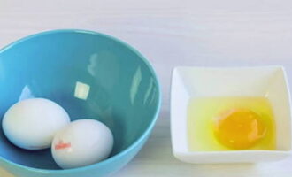 Carefully crack the egg into a small bowl, being careful not to damage the integrity of the yolk.