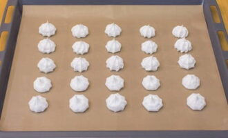 Cover a baking sheet with parchment. Using a pastry bag, place the meringue onto the baking sheet in the shape of small roses.