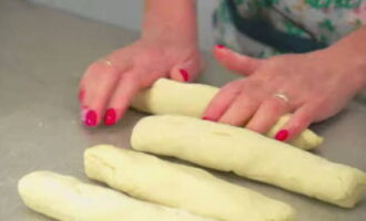 Knead the dough with your hands again and make strands out of it.