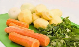 Let's do the vegetables. Peel the carrots, potatoes and onions and wash with water.