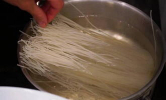 Boil 400 grams of rice noodles or pour boiling water in accordance with the instructions on the package. 