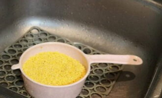 Place the millet in a colander and pour boiling water over it.