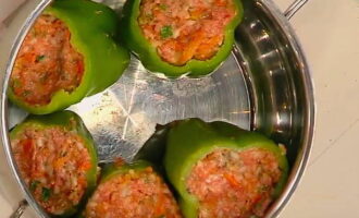 Each pepper is filled with rice and meat filling; the peppers are placed tightly together in a deep pan. 